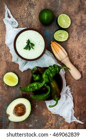 Preparing Avocado Cilantro Sauce For Fish Tacos. Lime Crema In A Bowl On Vintage Stone Background. Recipe For Cinco De Mayo Party. Top View.