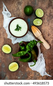 Preparing Avocado Cilantro Sauce For Fish Tacos. Lime Crema In A Bowl On Vintage Stone Background. Recipe For Cinco De Mayo Party. Top View. Flat Lay