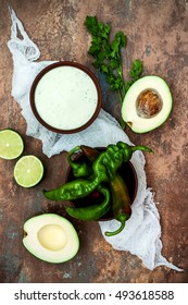 Preparing Avocado Cilantro Sauce For Fish Tacos. Lime Crema In A Bowl On Vintage Stone Background. Recipe For Cinco De Mayo Party. Top View. Flat Lay