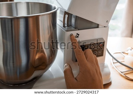 Preparing for Baking with a Stand Mixer: A Close-Up of Operating the Machine
