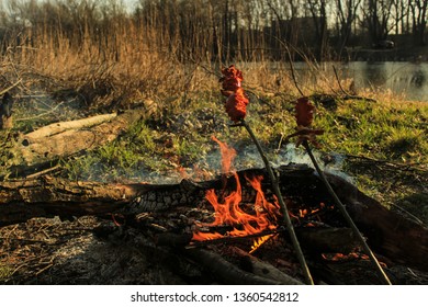 Preparing barbecue on fire in nature. Camping. - Shutterstock ID 1360542812