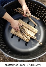 Preparing The Bbq Fire Pit With Firewood And Sticks 