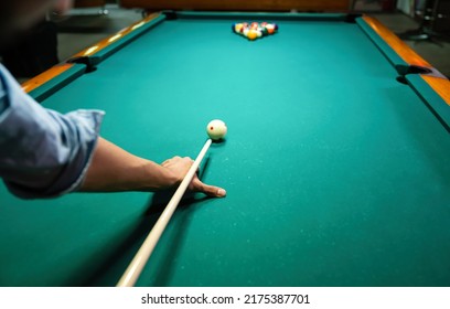 Preparing to break spheres into the pool pocket. People billiard, snooker entertainment concept. - Shutterstock ID 2175387701