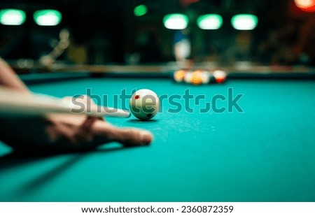 Preparing to break spheres into the pool pocket. People billiard, snooker entertainment concept.