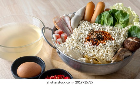 Preparing For Budae-jjigae (Army Stew) At Home, Korean Instant Ramen In Hot Pot With Sausage And Vegetable