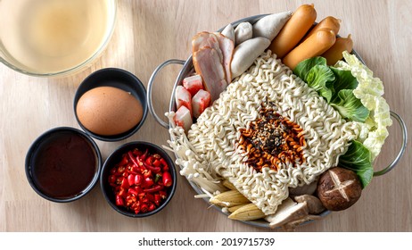 Preparing For Budae-jjigae (Army Stew) At Home, Korean Instant Ramen In Hot Pot With Sausage And Vegetable