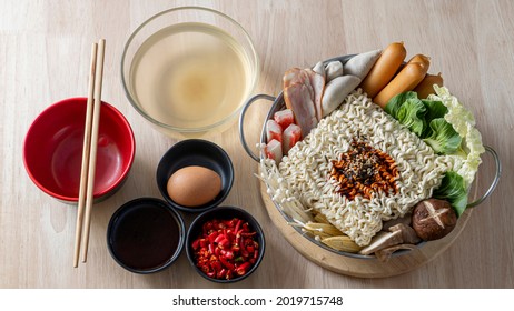 Preparing For Budae-jjigae (Army Stew) At Home, Korean Instant Ramen In Hot Pot With Sausage And Vegetable