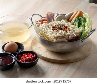 Preparing For Budae-jjigae (Army Stew) At Home, Korean Instant Ramen In Hot Pot With Sausage And Vegetable