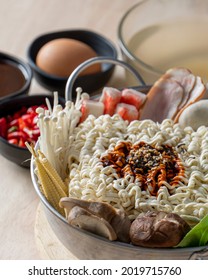 Preparing For Budae-jjigae (Army Stew) At Home, Korean Instant Ramen In Hot Pot With Sausage And Vegetable