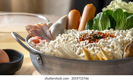 Preparing For Budae-jjigae (Army Stew) At Home, Korean Instant Ramen In Hot Pot With Sausage And Vegetable