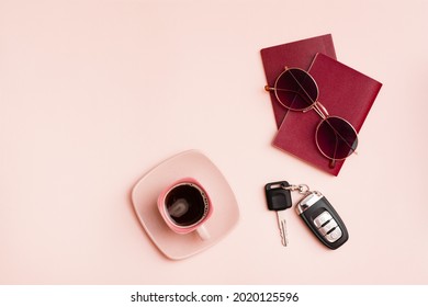 Preparing for a car trip. Passports, sunglasses, car keys and a cup of coffee on a pink background. Local tourism. Top view. Copy space