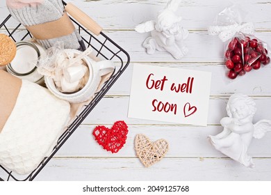 Preparing Care Package, Get Well Soon Gift Box With Warm Socks, Woolen Cover, Aroma Candle And Card. Personalized Eco Friendly Basket Wishig Recovery To Family And Friends. Top View, Flat Lay