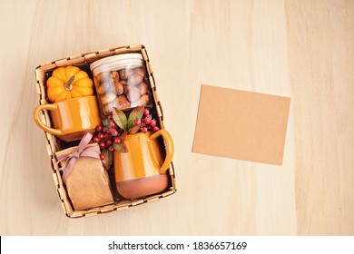 Preparing Care Package For Thanksgiving, Seasonal Gift Box With Cup, Tea Or Coffee Package And Cookies. Personalized Eco Friendly Basket For Fall Holidays. Top View, Flat Lay