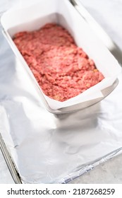 Preparing Classic Meatloaf In A Loaf Pan Lined With Parchment Paper.