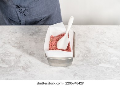 Preparing Classic Meatloaf In A Loaf Pan Lined With Parchment Paper.