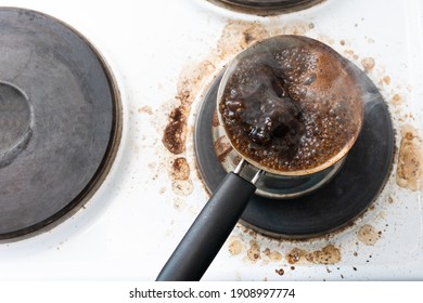 Preparing Coffee With Turkish Coffee Maker On A Stove, Dirty Stove, Top View