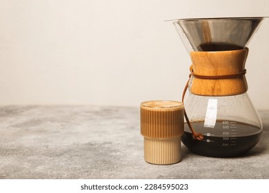 Preparing coffee using Chemex, pour coffee maker and drip kettle. Alternative ways to brew coffee.Coffee shop concept.Creamy latte with cream. Vanilla raf.