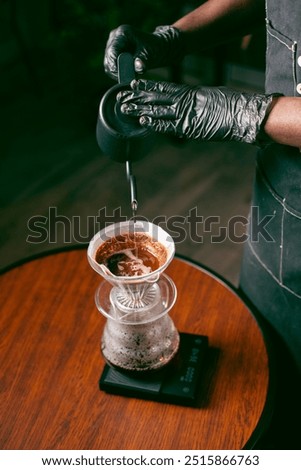 Preparing dark drip coffee in the café