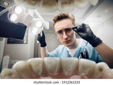 Preparing. Doctor looking into mouth, checking, examining teeth. Using professional tools and equipments. Healthcare and medicine, stomatology, feelings of patient. Look from inside the teeth.