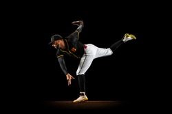 Preparing For Double. Professional Baseball Player, Pitcher In Sports Uniform And Equipment Practicing Isolated On A Black Studio Background. Competition, Show And Team Sport Concept. Copy Space For