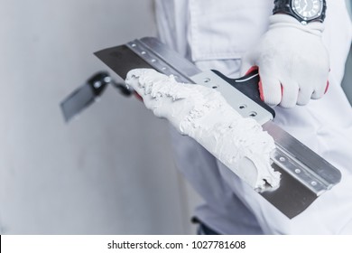 Preparing For Drywall Patch. Patching Tools in Hand of Worker Closeup Photo