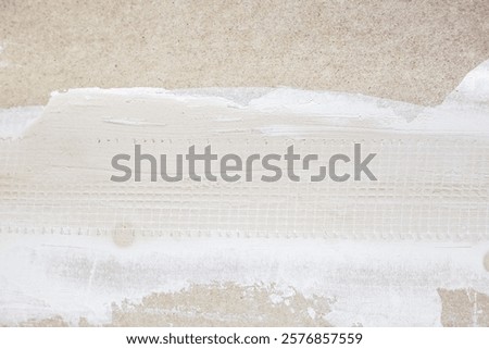 Preparing drywall for plastering. The drywall joint is filled and reinforced with reinforced tape.