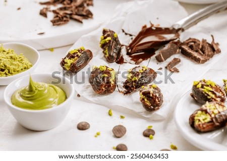Preparing exquisite dessert, dates filled with pistachio mousse, alternative to popular Dubai chocolate bar