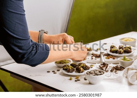 Preparing exquisite dessert, dates filled with pistachio mousse, alternative to popular Dubai chocolate bar