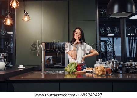 brunette caucasian woman preparing healthy food in kitchen