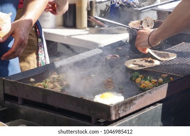 Preparing Food On A Grill For  The Ballard Farmer's Market On A Spring Day In Seattle, Washington