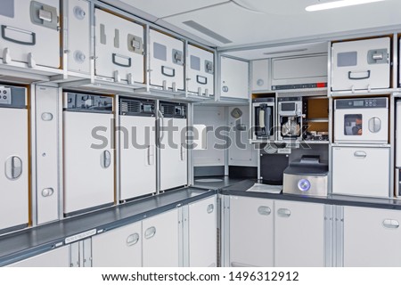 Preparing food for the passengers in the empty kitchen corner inside airplane