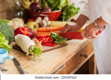 Preparing fruit salad.Senior woman cutting pomegranate.Hands are in focus. - Powered by Shutterstock