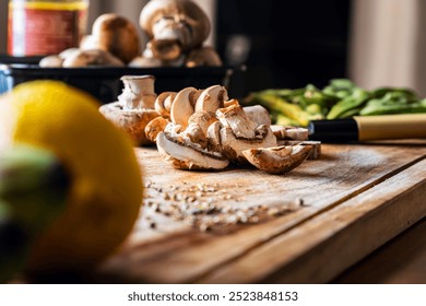 preparing healthy dinner in the kitchen, thinly sliced swiss brown mushroom on a wooden cutting board, healthy food concept