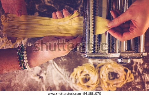 Preparing home made\
pasta with pasta\
maker.