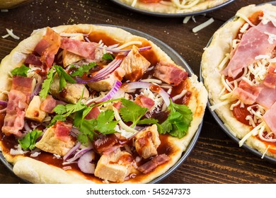 Preparing Individual Pizzas From Pizza Bar.