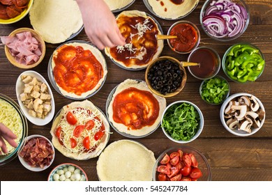 Preparing Individual Pizzas From Pizza Bar.