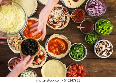 Preparing Individual Pizzas From Pizza Bar.