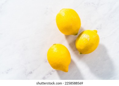 Preparing lemon swirls from the organic lemon to decorate the cocktail. - Shutterstock ID 2258588569