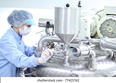 Preparing machine for work in pharmaceutical factory. Chemical industry. Pharmaceutical Factory Worker. Pharmaceutical Industry.