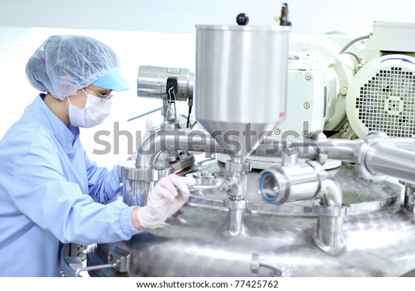 Preparing machine for work in pharmaceutical\
factory. Chemical industry. Pharmaceutical Factory Worker.\
Pharmaceutical\
Industry.