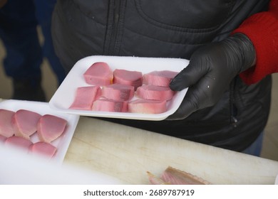 Preparing meat samples for tasting at a local event