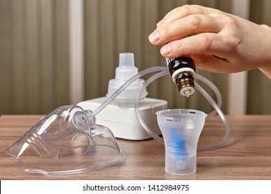 Preparing medicines for patients with asthma or idiopathic pulmonary fibrosis with nebulizer for breathing treatments on the table.