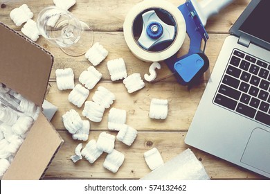 Preparing For Moving. Packing Supplies Next To A Laptop, On A Vintage Wooden Table