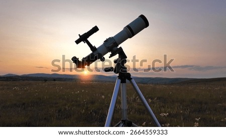 Preparing for night sky observing with a astronomical telescope just before sunset in the countryside.