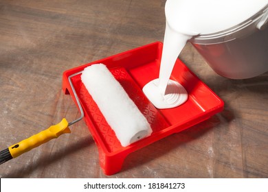 Preparing For Painting, Pouring Paint From Bucket Into A Paint Tray. 