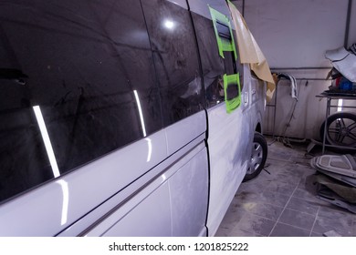 Preparing For Painting A Silver Bus In A Body Repair Shop In A Separate Box Service Station. Putting Putty And Leveling The Surface Of The Door Before Painting.