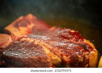 Preparing a ​​steak in a pan.