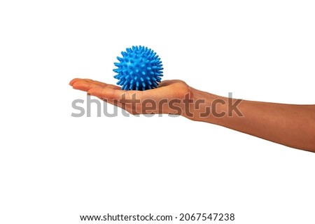 Preparing for physical therapy at home, Relaxation with a massage ball. Blue spiky silicone ball on the little woman's hand. Removal of fatigue after a hard day's work.