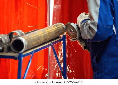 Preparing pipes for installation. Hands man sawing pipeline. Craftsman grinds pipe for installation utilities. Cropped factory workers use circular saw. Production of pipes for industrial enterprises - Powered by Shutterstock