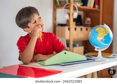 Preparing For School.Thoughtful Primary School Boy Solving Problems In An Educational Lesson, He Wears A Red Shirt And Is At The Desk In His Study Room, Using School Supplies.Homework.  - Powered by Shutterstock